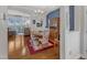 Open-concept dining room connected to the living area with hardwood floors and a view of the fireplace at 12227 Orchardgrass Ln, Raleigh, NC 27614