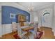 Elegant dining room showcasing hardwood floors, chandelier, and stylish decor at 12227 Orchardgrass Ln, Raleigh, NC 27614