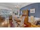 Dining room showcasing hardwood floors, chandelier, and seamless flow into the living room at 12227 Orchardgrass Ln, Raleigh, NC 27614
