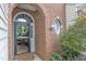 Close-up of the front door, showcasing the brick arched entry and decorative wreath at 12227 Orchardgrass Ln, Raleigh, NC 27614
