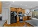 Kitchen featuring wood cabinets, black appliances, and ample counter space for cooking and meal preparation at 12227 Orchardgrass Ln, Raleigh, NC 27614
