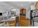 Open kitchen with breakfast bar, wood cabinets, and seamless flow to the living spaces at 12227 Orchardgrass Ln, Raleigh, NC 27614