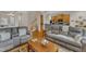 Cozy living area features plush seating, warm wood floors, and an inviting atmosphere for relaxation at 12227 Orchardgrass Ln, Raleigh, NC 27614