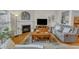 Comfortable living room featuring a fireplace, large windows, and a cozy seating arrangement at 12227 Orchardgrass Ln, Raleigh, NC 27614