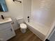 Bathroom featuring a shower/tub combo with tile surround, modern toilet, and sleek vanity at 1225 Gay St, Rocky Mount, NC 27804