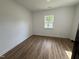 Neutral bedroom showcasing new floors, fresh paint, a single window, and new door at 1225 Gay St, Rocky Mount, NC 27804