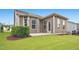 Green backyard features earth tone home exterior, trimmed lawn, and mulch at 12309 Aberdeen Chase Way, Durham, NC 27703