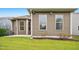 View of the backyard featuring a well-maintained lawn and earth tone siding at 12309 Aberdeen Chase Way, Durham, NC 27703
