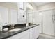 Elegant bathroom with dual sinks, granite counters, and glass-enclosed shower at 12309 Aberdeen Chase Way, Durham, NC 27703