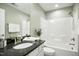Bathroom featuring granite countertop and shower with tub at 12309 Aberdeen Chase Way, Durham, NC 27703