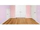 Bedroom with hardwood floors and a double door closet at 12309 Aberdeen Chase Way, Durham, NC 27703