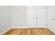 A simple bedroom with wood floor and double door closet at 12309 Aberdeen Chase Way, Durham, NC 27703