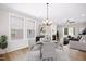 Cozy dining area with windows providing natural light and fireplace views at 12309 Aberdeen Chase Way, Durham, NC 27703