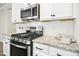Gourmet kitchen featuring granite counters, subway tile backsplash, and stainless steel oven and range at 12309 Aberdeen Chase Way, Durham, NC 27703