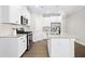 Modern kitchen with white cabinets, stainless steel appliances, and an island with a sink at 12309 Aberdeen Chase Way, Durham, NC 27703