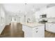 Open-concept kitchen featuring granite countertops, white cabinets, and seamless flow into dining area at 12309 Aberdeen Chase Way, Durham, NC 27703