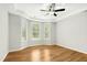 Spacious main bedroom with tray ceiling, ceiling fan, and bright sunny windows at 12309 Aberdeen Chase Way, Durham, NC 27703