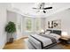 Relaxing main bedroom with tray ceiling, ceiling fan, and bright sunny windows at 12309 Aberdeen Chase Way, Durham, NC 27703