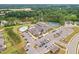 Aerial view of the community clubhouse with a pool and tennis courts at 1625 Plover Cir, Fuquay Varina, NC 27526