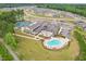 Aerial view of community amenities, including a pool, clubhouse, and tennis courts at 1625 Plover Cir, Fuquay Varina, NC 27526