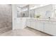 Bathroom boasts a double sink vanity, large mirror, and a walk-in shower with pebble flooring at 1625 Plover Cir, Fuquay Varina, NC 27526