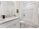 Clean, white bathroom featuring a shower-tub combo and a granite vanity top at 1625 Plover Cir, Fuquay Varina, NC 27526