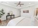 Airy bedroom with tray ceiling, wood-look flooring, stylish decor, and soft, neutral bedding at 1625 Plover Cir, Fuquay Varina, NC 27526