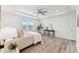 Bright bedroom with a tray ceiling, a large window, and a stylish decor with neutral colors at 1625 Plover Cir, Fuquay Varina, NC 27526
