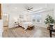 Bright bedroom with a tray ceiling, large window, a cozy rug, and an en-suite bathroom for comfort and privacy at 1625 Plover Cir, Fuquay Varina, NC 27526