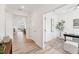 Inviting hallway leading to an office featuring sleek wood floors and neutral tones at 1625 Plover Cir, Fuquay Varina, NC 27526