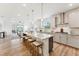 Open kitchen with granite counters, island seating, and stainless appliances flows into the living area at 1625 Plover Cir, Fuquay Varina, NC 27526