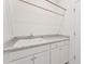 Laundry room featuring a utility sink with white cabinets and quartz countertops at 1625 Plover Cir, Fuquay Varina, NC 27526