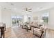 Bright living room featuring hardwood floors, neutral décor, and access to the screened porch at 1625 Plover Cir, Fuquay Varina, NC 27526
