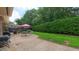 Lush backyard featuring a paved patio with outdoor seating, a grill, and ample green space at 1815 Hawthorne Ln, Burlington, NC 27215