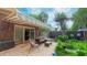 Inviting backyard featuring a paved patio area with comfortable seating beneath a striped awning at 1815 Hawthorne Ln, Burlington, NC 27215