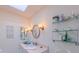 Well-lit bathroom featuring a vanity with double mirrors, and glass shelving at 1815 Hawthorne Ln, Burlington, NC 27215