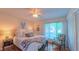 Cozy bedroom with natural light, a ceiling fan, and a comfortable bed at 1815 Hawthorne Ln, Burlington, NC 27215