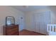 View of Bedroom with closet, dresser, and wood floors offers functionality and charm at 1815 Hawthorne Ln, Burlington, NC 27215
