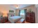 Comfortable bedroom with light blue bedspread, ceiling fan, and stylish decor for a peaceful retreat at 1815 Hawthorne Ln, Burlington, NC 27215