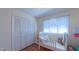 Cozy Bedroom with a white crib, bright natural light, and a closet for ample storage at 1815 Hawthorne Ln, Burlington, NC 27215