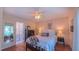 Bright bedroom with wooden floors, an elephant print, and ensuite bathroom at 1815 Hawthorne Ln, Burlington, NC 27215