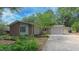 Charming exterior elevation features a brick facade, attached garage, and mature landscaping at 1815 Hawthorne Ln, Burlington, NC 27215