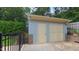 Detached garage featuring a single door and a pedestrian door on a concrete driveway at 1815 Hawthorne Ln, Burlington, NC 27215