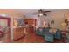 View of the living room that features a kitchen counter, wooden floors, ceiling fan, and comfortable furniture at 1815 Hawthorne Ln, Burlington, NC 27215