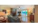 Spacious living room with a brick fireplace, ceiling fan, and sliding glass doors to the backyard at 1815 Hawthorne Ln, Burlington, NC 27215