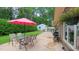 Inviting patio with outdoor dining area, grill, and lush backyard provides a relaxing outdoor space at 1815 Hawthorne Ln, Burlington, NC 27215