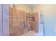 Attractive tiled shower with dual shower heads, niche, and hand-held sprayer provides a spa retreat at 1815 Hawthorne Ln, Burlington, NC 27215