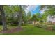 Green lawn with a split rail fence and mature trees provide a peaceful setting at 1815 Hawthorne Ln, Burlington, NC 27215
