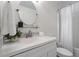 Well-lit bathroom featuring a vanity with a vessel sink, round mirror and shower at 1851 Trailwood Heights Ln, Raleigh, NC 27603