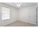 Bright bedroom with a window, carpet, and a white door at 1851 Trailwood Heights Ln, Raleigh, NC 27603